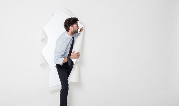 office man with elegant outfit and tie breaking the paper backgr - Photo, image