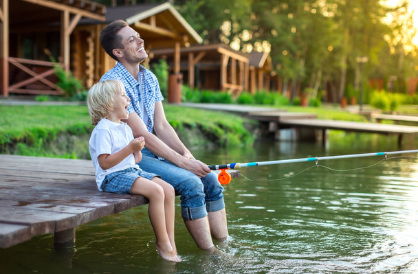 Dad with son fishing outdoors - Photo, Image