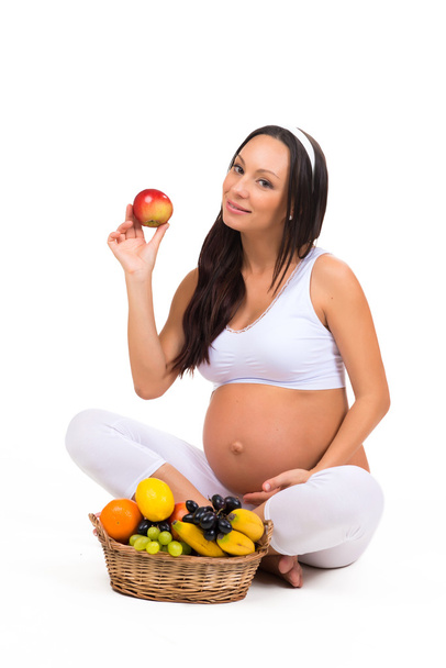 Proper nutrition during pregnancy. Vitamins and fruit. Pregnant women eating apple - Foto, Imagem