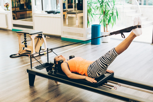 Woman stretching in pilates reformer  - Zdjęcie, obraz