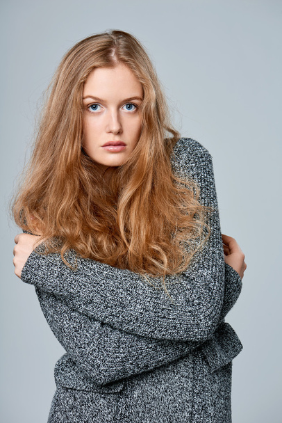 Woman muffling in warm knitted cardigan - Photo, image