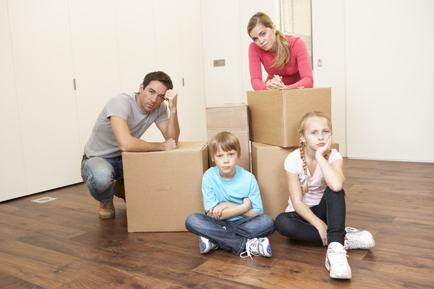 Young family looking upset among boxes - Photo, image