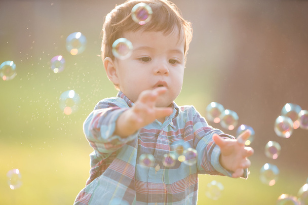 boy is catching bubbles  - Foto, Imagen