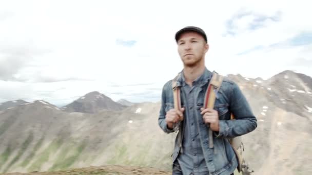 Outdoor portrait of Young man hiking on the mountains,smiling happy portrait of tourist male.extreme sport - Footage, Video