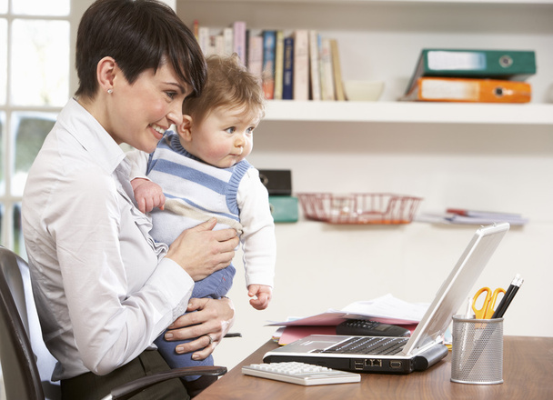 Woman With Baby Working From Home Using Laptop - Foto, Imagem