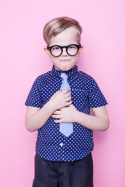 Stylish boy in shirt and glasses with big smile. School. Preschool. Fashion. Studio portrait over pink background - Valokuva, kuva