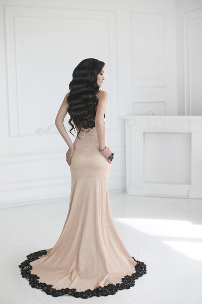Elegant lady in dress. Beautiful fashion brunette woman in prom  - Fotó, kép