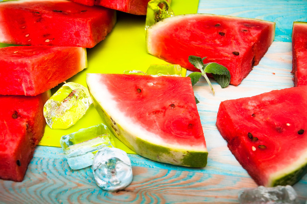 Pieces of watermelon on blue wooden background - Фото, зображення