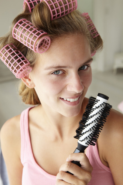 Teenage girl with hair in curlers - Φωτογραφία, εικόνα
