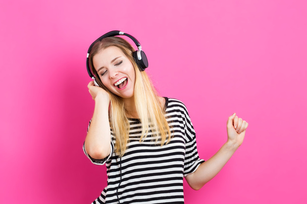 Happy young woman with headphone - Fotó, kép