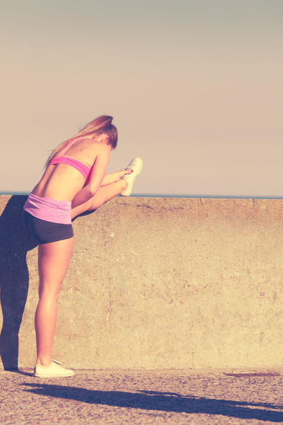 Woman doing sports exercises outdoors by seaside - Foto, Bild