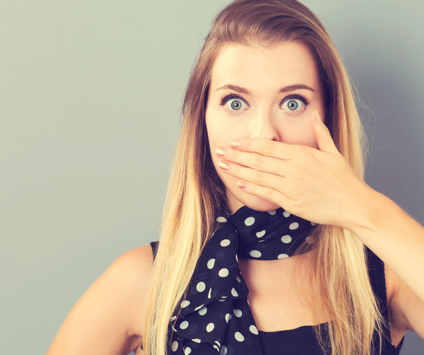 Young woman covering her mouth - Photo, Image