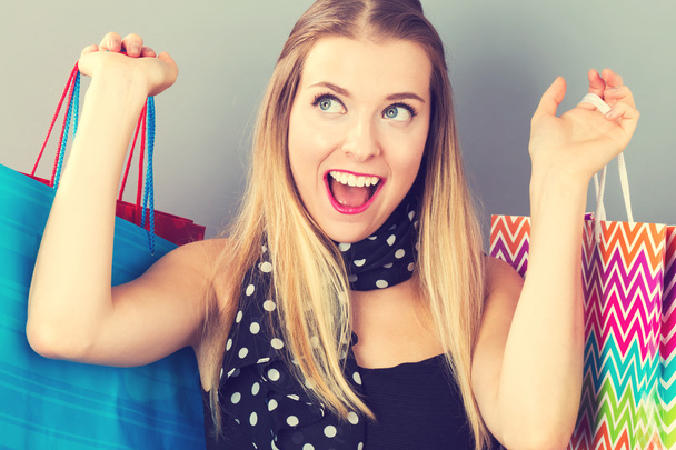 Happy woman holding many shopping bags - Foto, Imagem