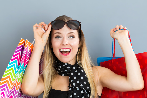 Happy woman holding many shopping bags - Foto, Imagem
