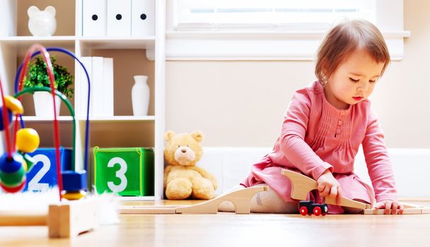 Happy toddler girl playing with toys - Фото, зображення