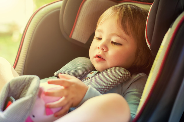 Toddler girl in her car seat - Фото, изображение