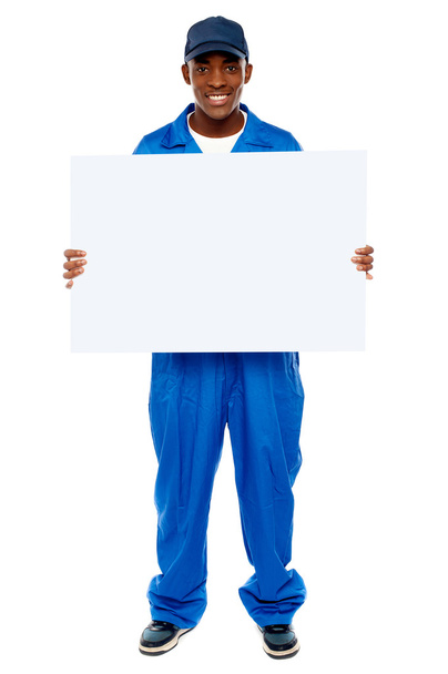 Courier guy presenting blank white billboard - Fotó, kép