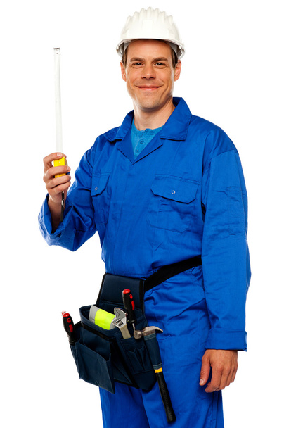 Building worker holding measuring tape - Foto, Imagen