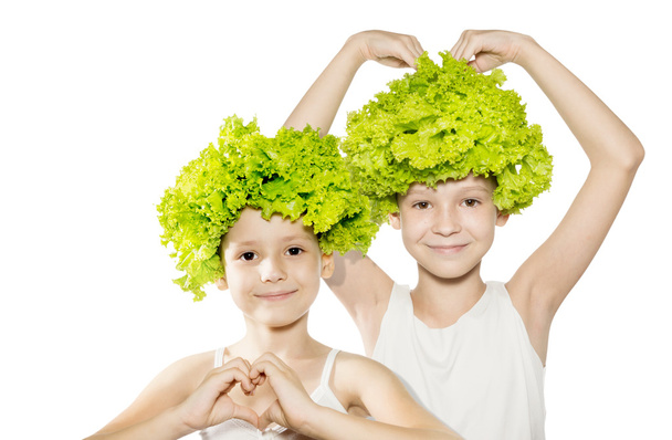 Two little girls with lettuce hair holding hands in heart shape - Photo, Image