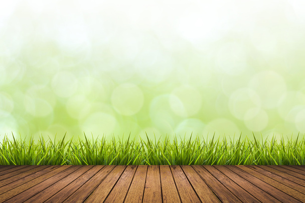 Wooden floor, grass and green blurred background - Foto, Imagem