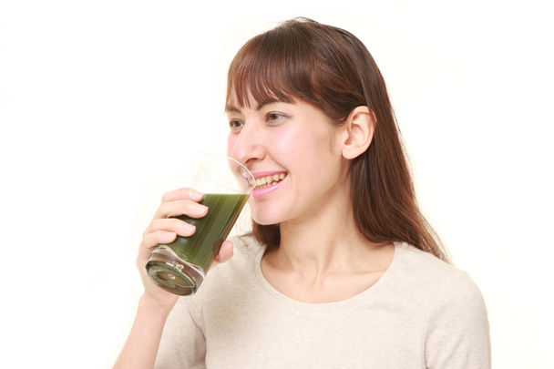 young woman with green vegetable juice - Foto, imagen