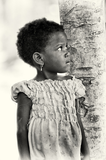 A Benin young girl watches at her mother - Photo, image