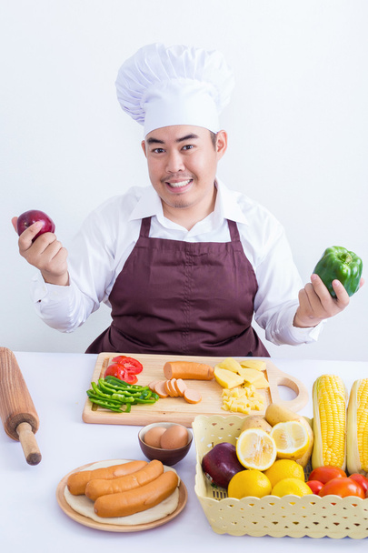 Portret van een chef-kok houden van groenten en fruit - Foto, afbeelding