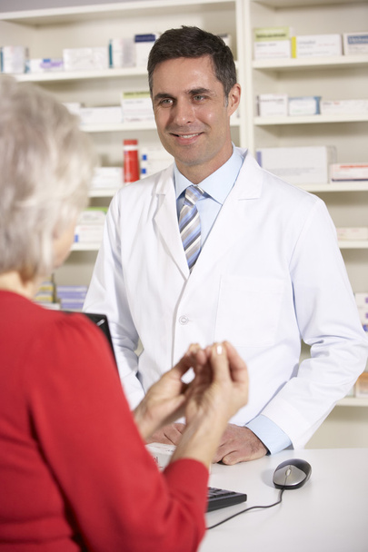 American pharmacist with senior woman in pharmacy - Fotó, kép