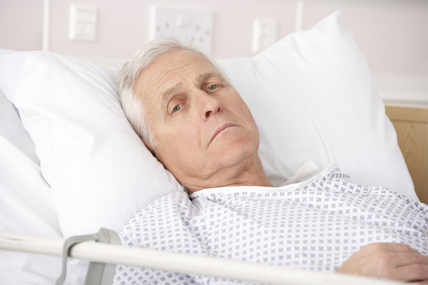 Senior man ill in hospital bed - Фото, изображение