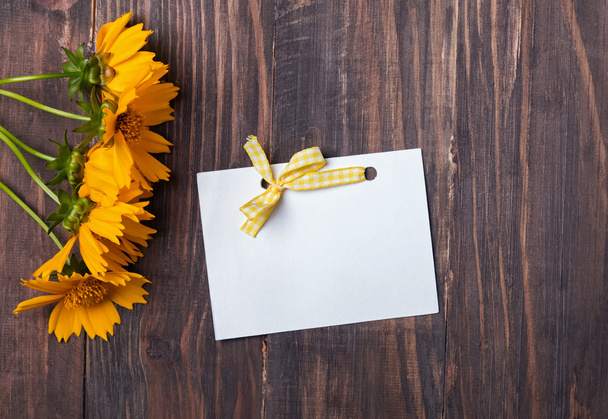 Yellow flowers and blank paper card - Foto, Imagen