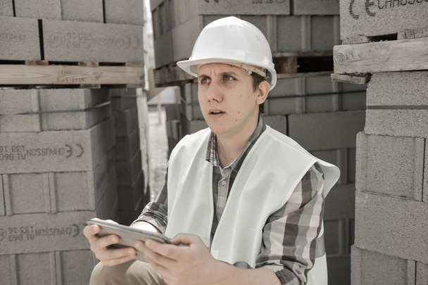 Foreman using digital tablet on construction site - Foto, afbeelding