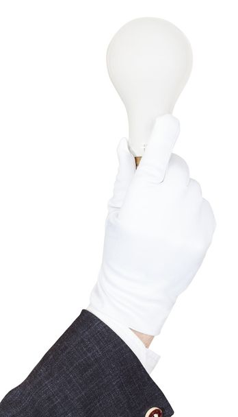 mano masculina en traje y guante sostiene luz de la bombilla
 - Foto, imagen