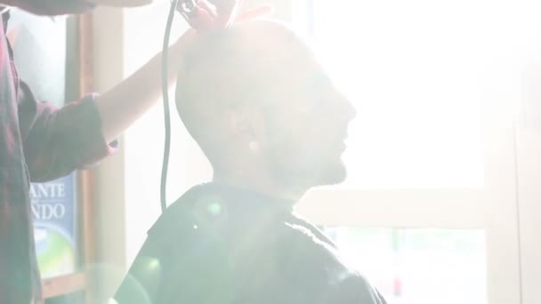 Woman barber cutting hair of man  - 映像、動画