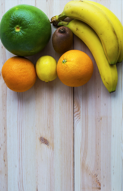 Fresh exotic fruits on wooden table - Фото, изображение