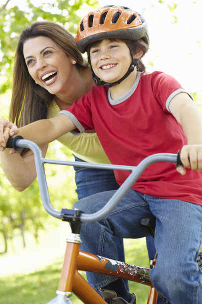 Boy on bike with mother - Foto, imagen