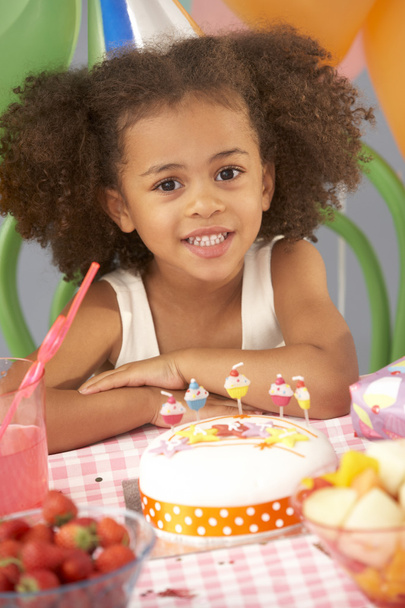 Young girl with birthday cake at party - Фото, изображение