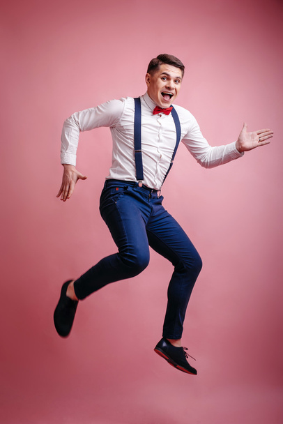 young cheerful stylishly dressed man in a jump - Фото, зображення