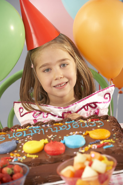 Young girl with birthday cake at party - Фото, изображение