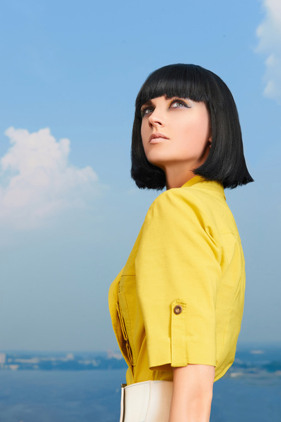 girl with bob hairstyle over blue sky - Foto, imagen