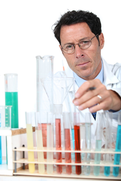 50 years old scientist in a lab behind test tubes - Photo, image
