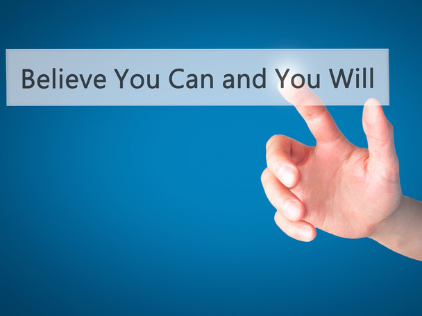 Believe You Can and You Will - Hand pressing a button on blurred - Foto, Imagen