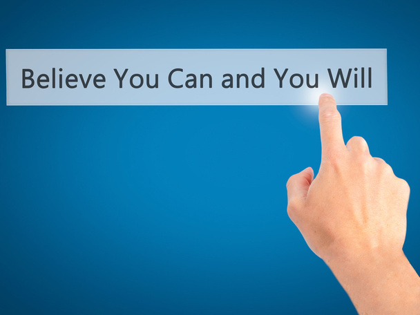 Believe You Can and You Will - Hand pressing a button on blurred - Foto, afbeelding
