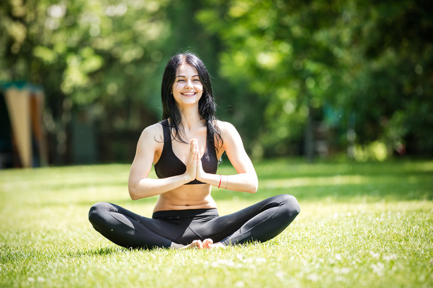 Smiling woman siting in lotus position  - Photo, Image