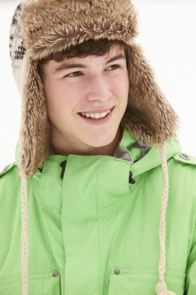 Portrait Of Teenage Boy In Snow Wearing Fur Hat - Photo, Image