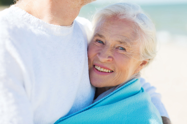happy senior couple hugging on summer beach - Photo, Image