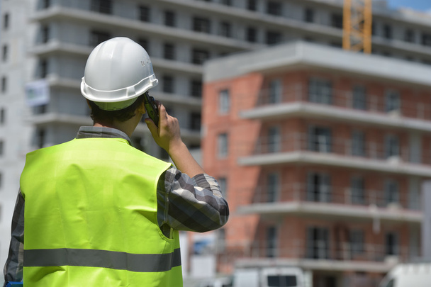 Foreman using walkie-talkie on construction site - 写真・画像