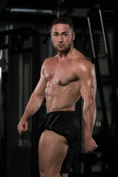 Healthy Young Man Flexing Muscles - Fotoğraf, Görsel