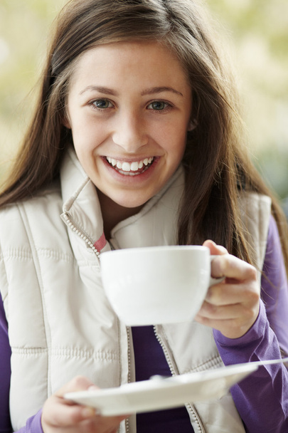 Teenage Girl In Outdoor Café With Hot Drink Wearing Winter Clot - Φωτογραφία, εικόνα