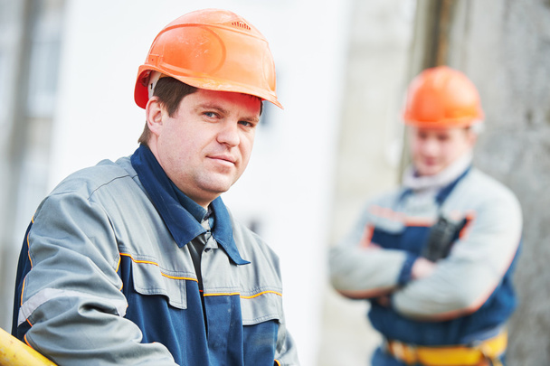 Portrait of two workers at construction site - Zdjęcie, obraz