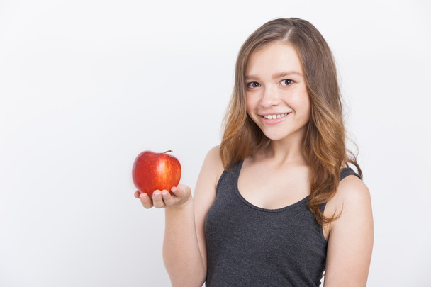 Smiling girl with apple - Φωτογραφία, εικόνα